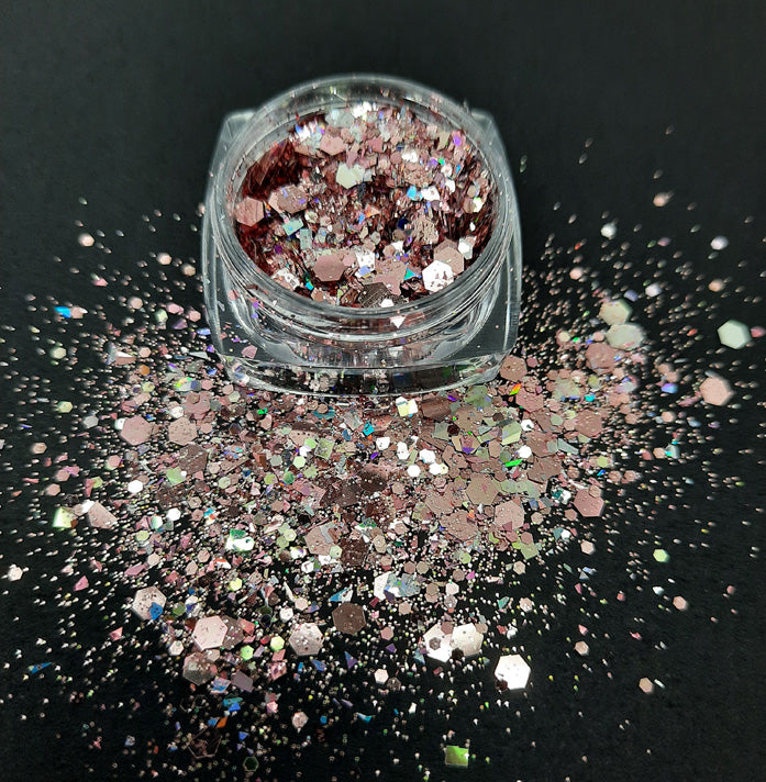 A pot of shiny chunky glitter in a rose gold colour, used for nail art and also arts and crafts.
