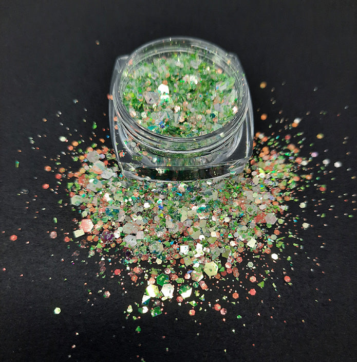 A pot of chunky iridescent, shiny green glitter used in nail art and also arts and crafts.