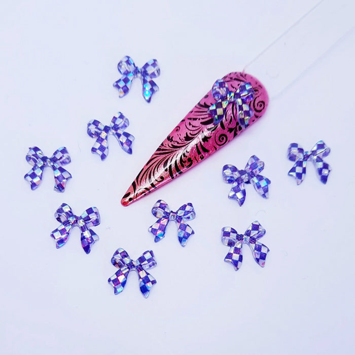 chequered ribbon bows used for nail art on a light coloured background