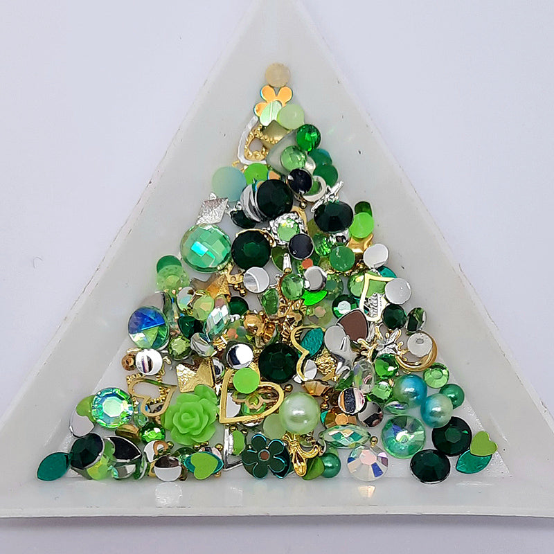 Nail Art Decoration Treasure Pot, Green. These treasure pots are packed full of a wide variety of nail decoration. Colour themed, and with added gold and silver metal pieces. Other colour varieties also available.