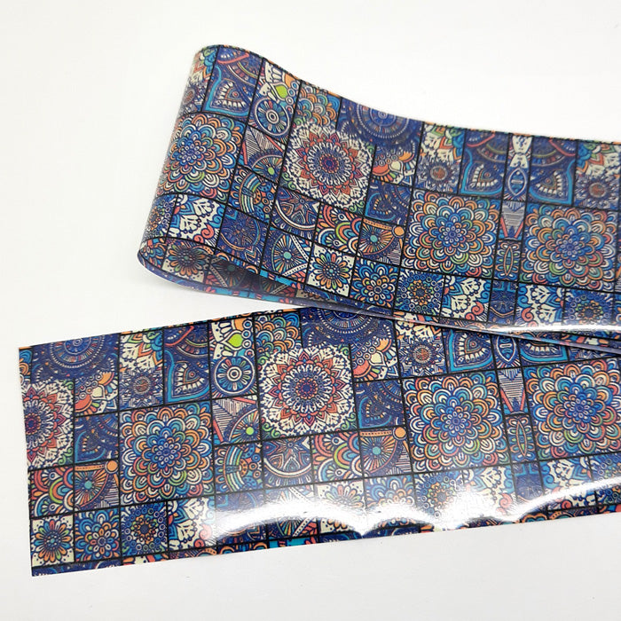 A strip of nail foil with a detailed mandala design.