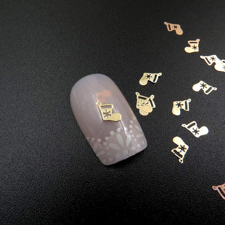 Gold metal nail slices with a Christmas stocking design.