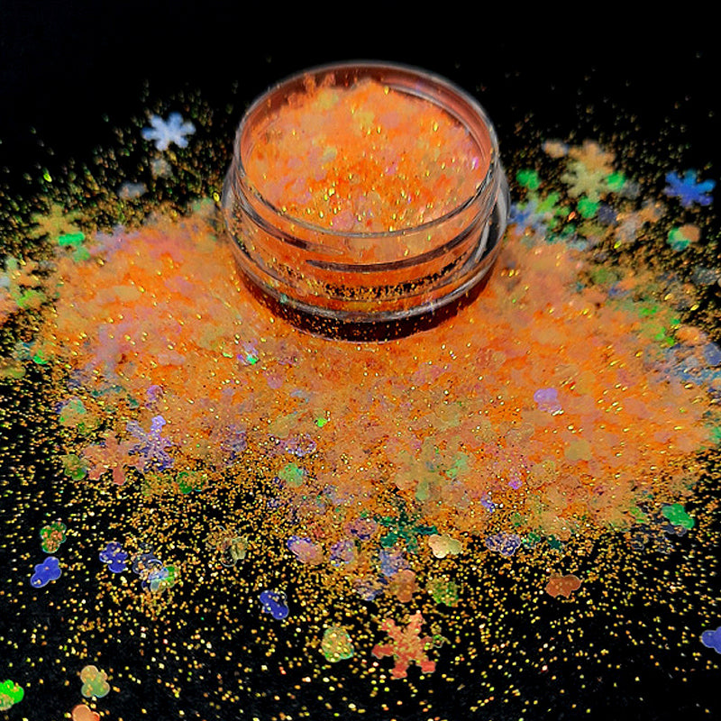 Christmas Nail Glitter 'Tangerine Blizzard'. This Christmas nail glitter is intense! Clear iridescent 5mm snowflakes and clouds amongst an intensely sparkly orange powder.