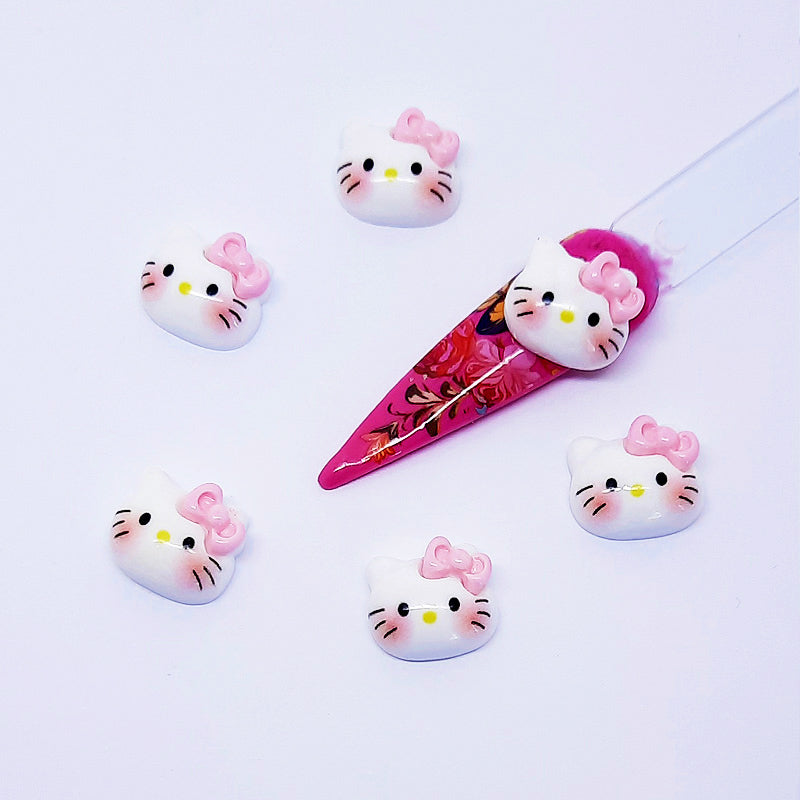 Set of Hello Kitty-themed nail art charms on a white background