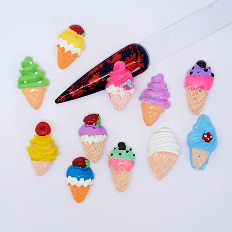 Colourful ice cream cone-shaped nail art charms on a white background