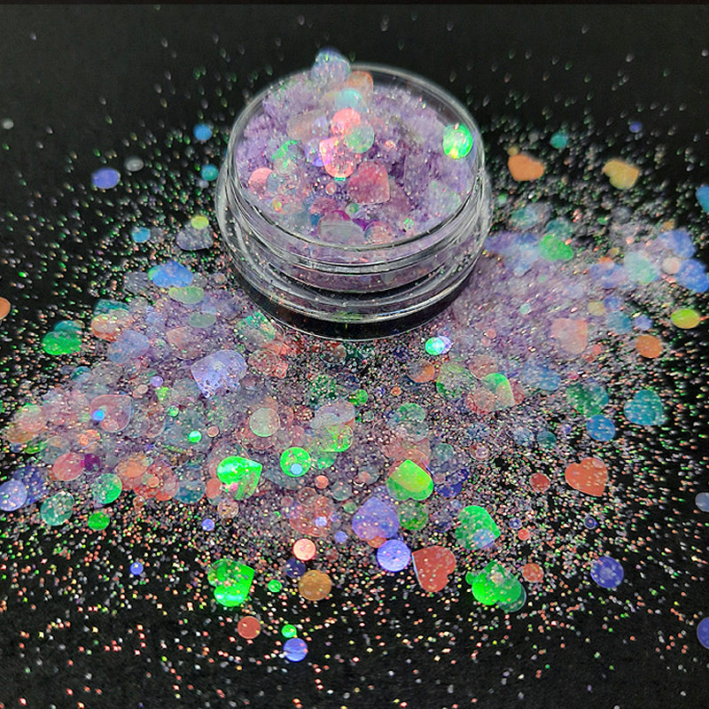 Lilac Nail Glitter 'Lilac Love'. A beautiful sparkly soft lilac nail glitter. Clear iridescent love hearts and different sized dots that shimmer green, red and purple, in a sparkly iridescent powder.