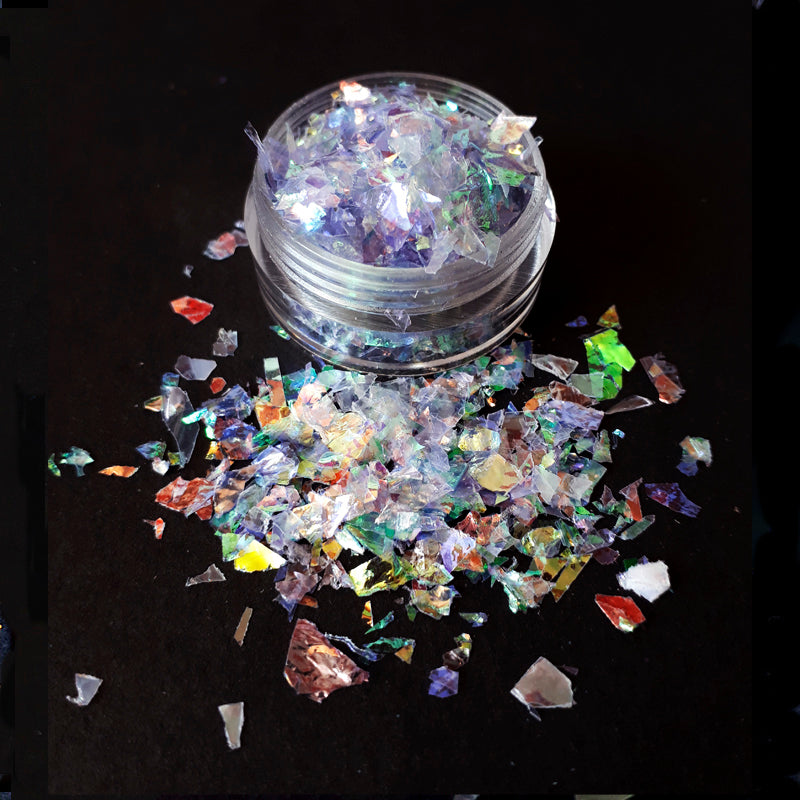 a pot of lilac coloured iridescent nail flakes on a black background