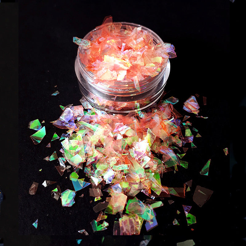 Iridescent glitter in a clear container on a black background