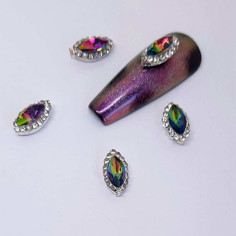 Oval Crystal Nail Charms, Rainbow x 2. Beautiful colour shift crystals set into a silver metal base and surrounded by smaller clear gems.