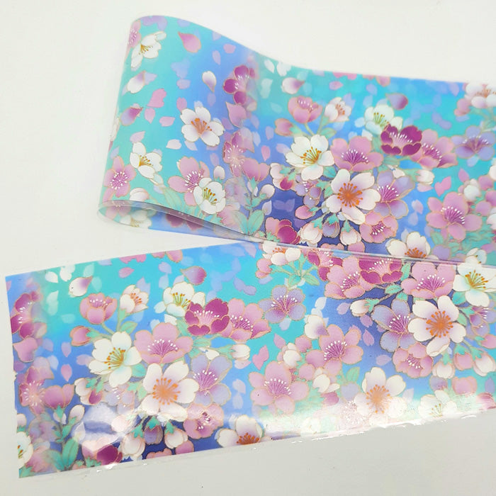 A strip of colourful nail foil with a floral design on a white background.