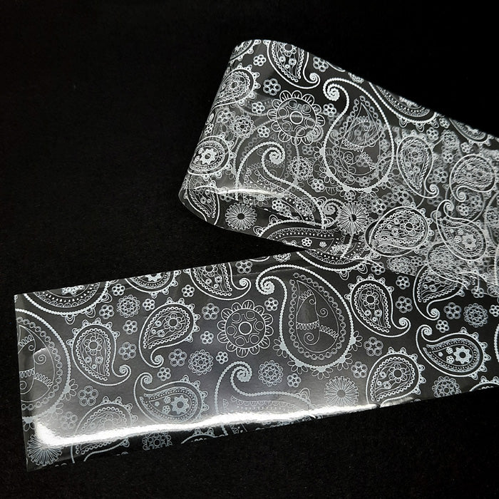 White Paisley Nail Foil. A beautiful white design on a clear backing.
Supplied in 4cm x 100cm lengths.