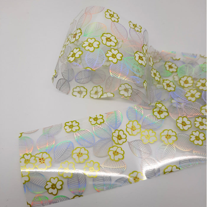 White Flowers + Silver Holo Leaves Nail Foil, beautiful design on clear backing.
Supplied in 4cm x 100cm lengths.