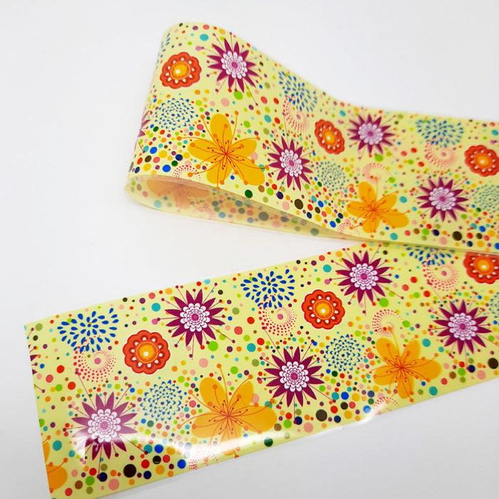 A strip of colourful floral-patterned nail foil on a white background