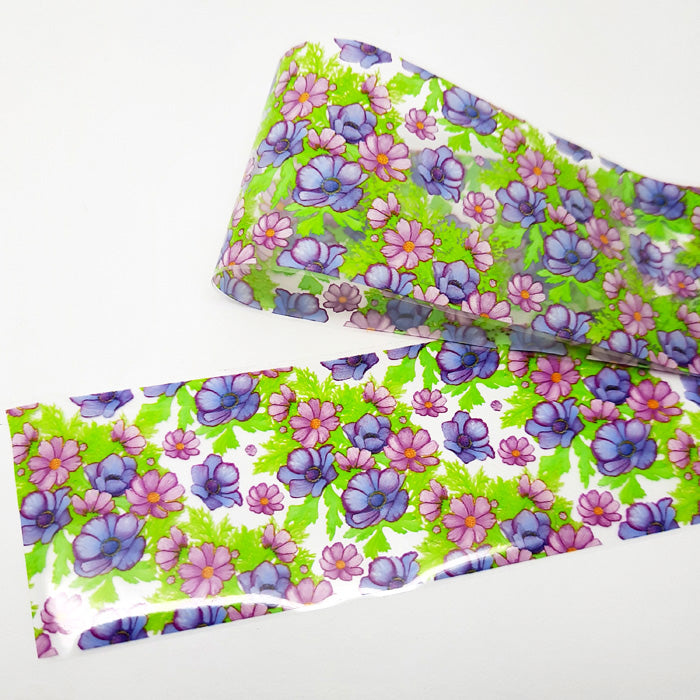 Floral patterned nail art foil with purple, pink, and green flowers on a white background