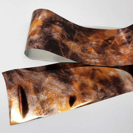 A strip of nail foil in bronze colours.
