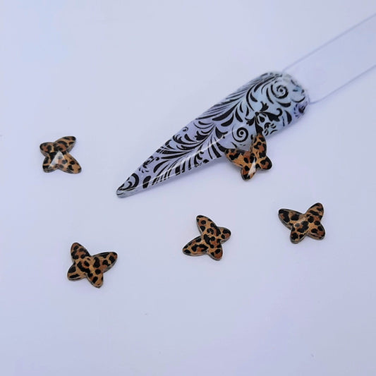 Clear Resin Animal Print Butterfly Nail Charms x 4, Brown. Beautiful butterfly charms. Other colours also available, plus matching heart charms.