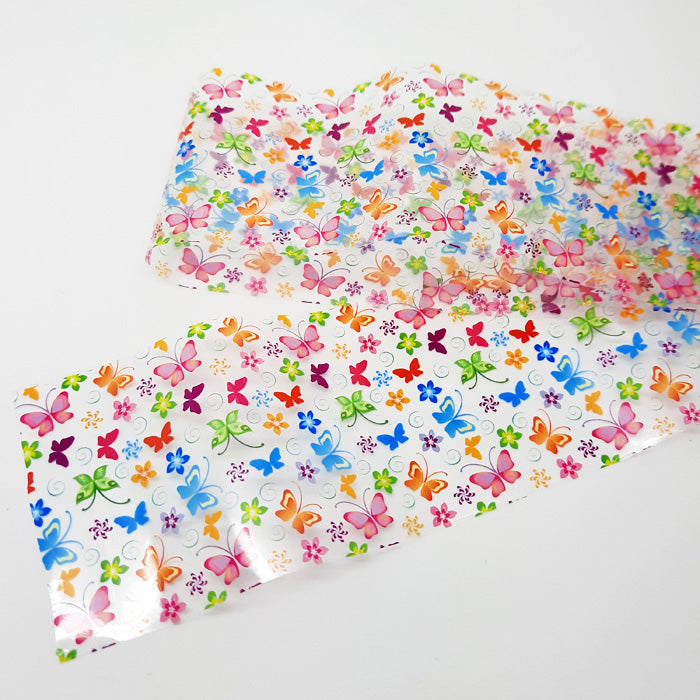 Strip of colourful butterfly nail foil on a white background