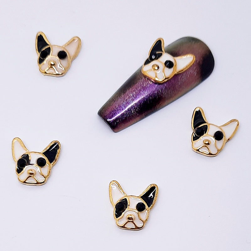 Set of dog-shaped nail charms used for nail art design on a white background