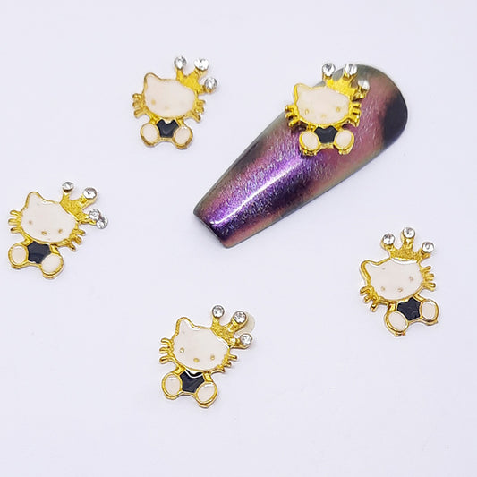 Gold Hello Kitty shaped nail decorations on a white background