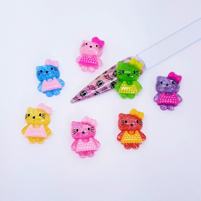 Colourful Hello Kitty nail art figurines on a white background