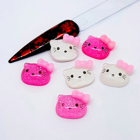 Set of Hello Kitty-themed nail art charms including a nail tip on a white background.