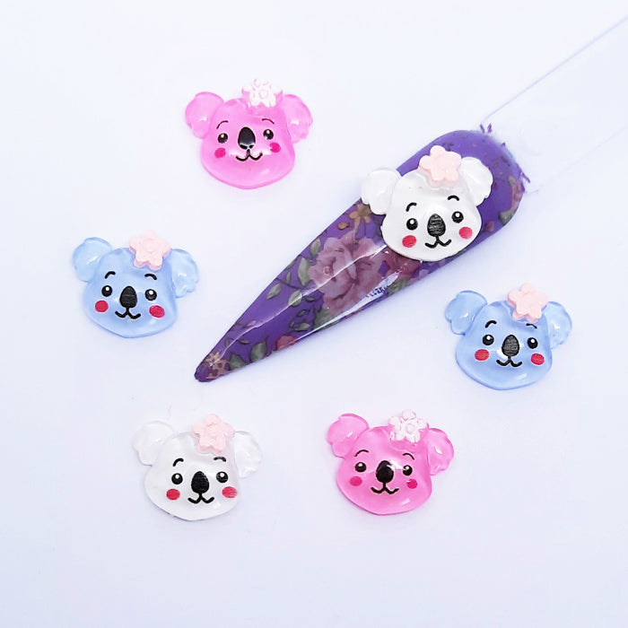 Set of cartoon koala-shaped nail art charms on a white background