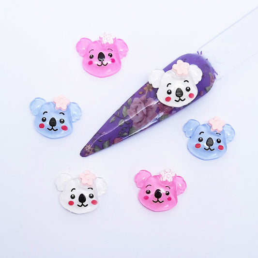Set of cartoon koala-shaped nail art charms on a white background