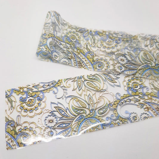 Patterned nail art foil with blue and gold design on a white background