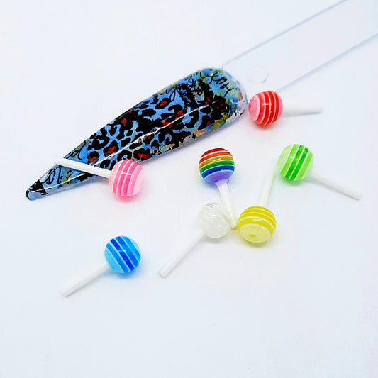 Colourful lollipop nail art charms with a leopard print nail tip on a white background