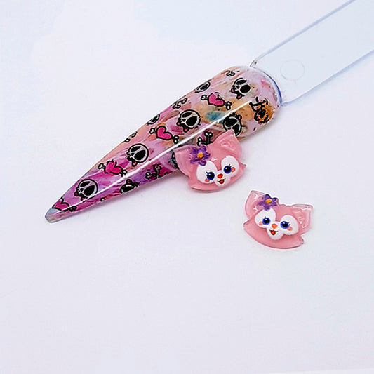 Pink fox nail art charms on a white background