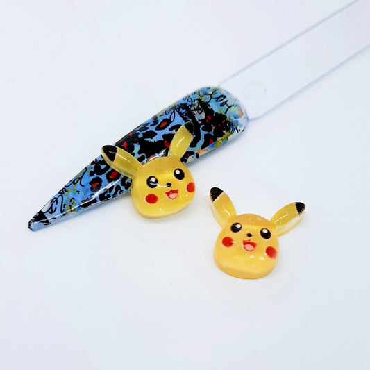 Two Pikachu nail art charms on a white background
