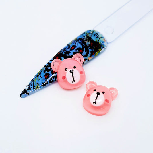 Pink teddy bear shaped nail art charms on a white background