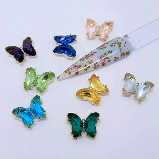 A collection of colourful crystal butterfly nail charms.