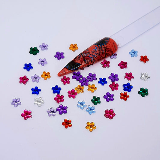 Pretty Little Flowers Nail Decoration x 25. These are really cute flowers in a lovely selection of colours. These's space for you to put a gem or pearl in the centre.

Supplied in a pack of 25 mixed colours.
