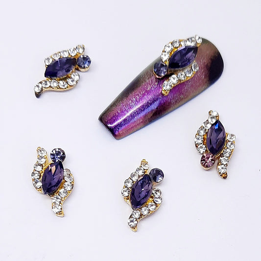 Purple nail art design with decorative elements on a white background