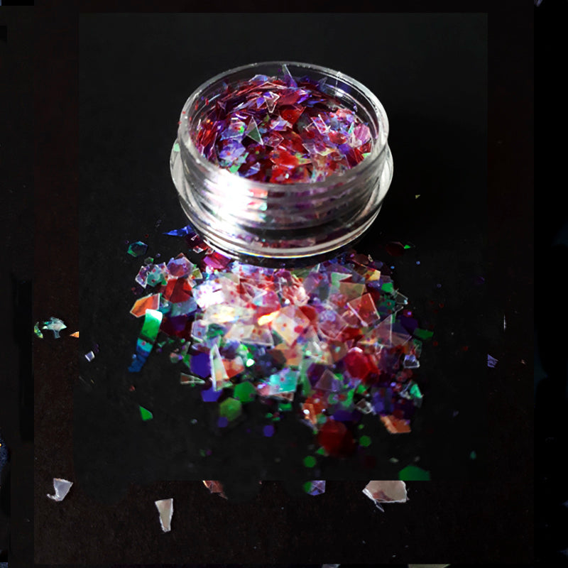 Colorful glitter in a clear container on a black background
