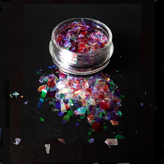Colorful glitter in a clear container on a black background