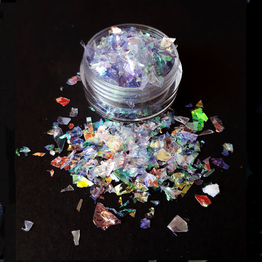 a pot of lilac coloured iridescent nail flakes on a black background