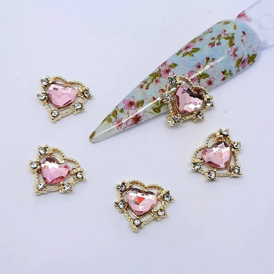 Pretty Pale Pink Hearts Nail Charms x 2. These are the most beautiful heart charms; a clear pink heart set in a gold frame and decorated with small clear gems.