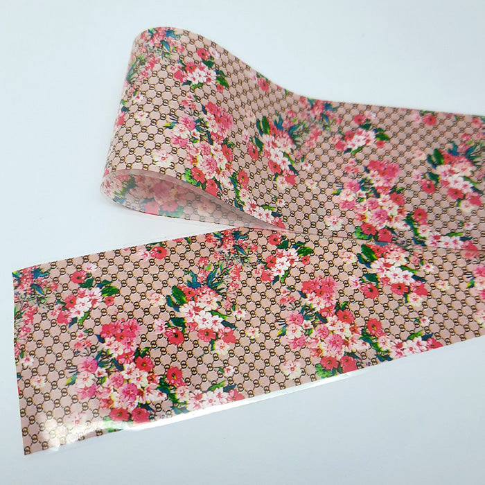 Floral patterned nail art foil with Gucci logo on a light grey background