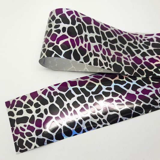 Purple + Black Giraffe Print Nail Foil. Beautiful design, black and purple with silver.

Supplied in 4cm x 100cm lengths.