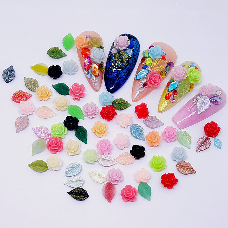 Colourful nail art decorations including flowers and leaves, on a white background