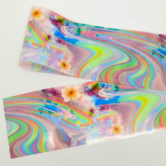 A strip of colourful nail art foil with a swirls and floral design on a white background.