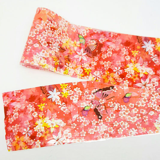 An orange nail art foil with a floral design on a white background