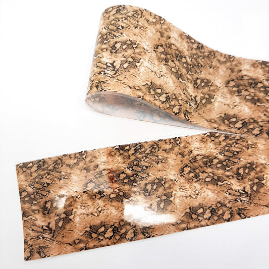 A strip of Snakeskin Nail Foil in a brown design on a white background.